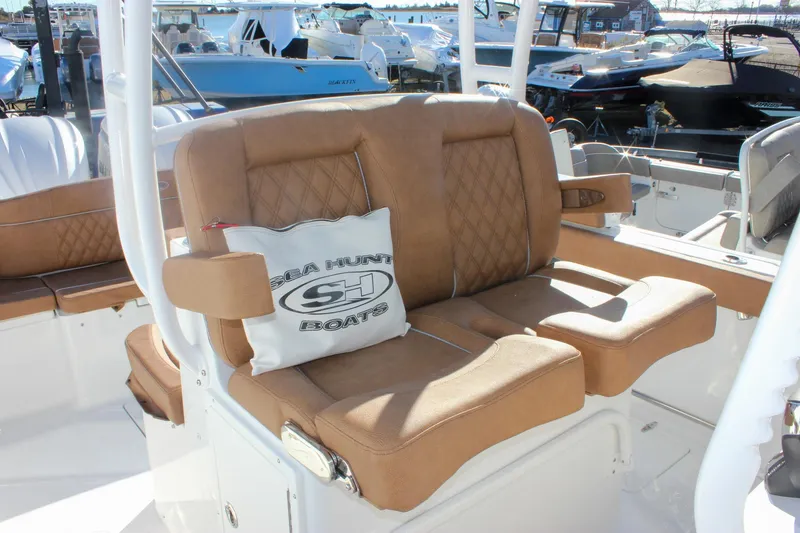 Slide: The Image of Luxurious seating on 2026 Sea Hunt Ultra 285 SE boat, featuring tan upholstery and branded cushion. - 24