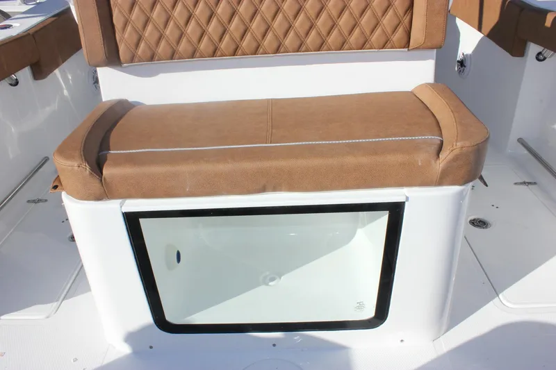 Slide: The Image of 2026 Sea Hunt Ultra 285 SE boat seat with storage compartment, brown upholstery. - 25