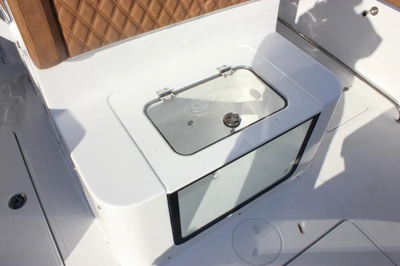 Slide: The Image of 2026 Sea Hunt Ultra 285 SE boat interior with cushioned seating and storage compartment. - 26