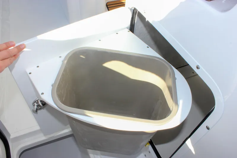 Slide: The Image of Storage compartment on 2026 Sea Hunt Ultra 285 SE boat, featuring a removable bin. - 27