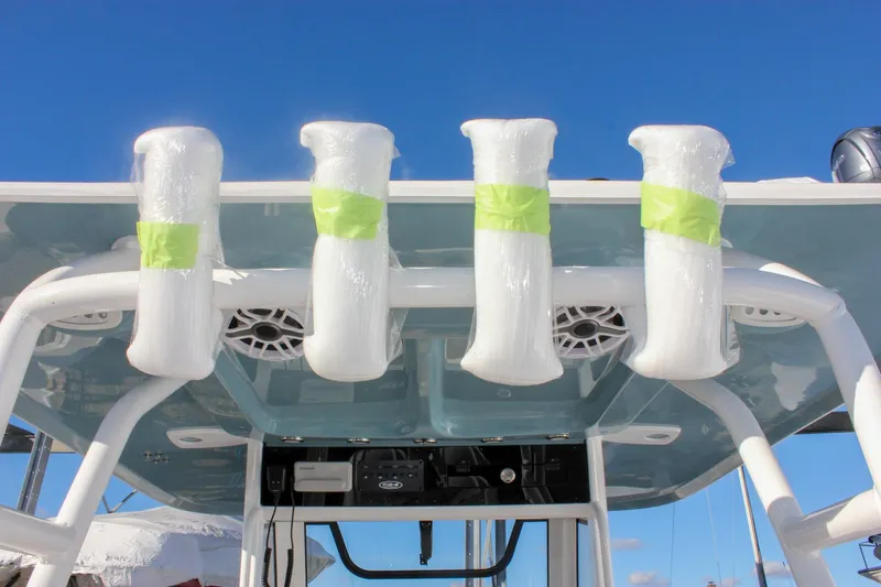 Slide: The Image of 2026 Sea Hunt Ultra 285 SE boat with wrapped rod holders under a clear blue sky. - 34