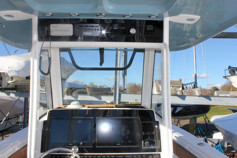 Slide: The Image of 2026 Sea Hunt Ultra 285 SE boat dashboard with navigation equipment and controls. - 36