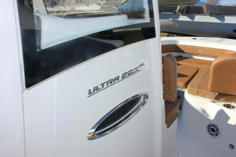 Slide: The Image of 2026 Sea Hunt Ultra 285 SE boat interior with brown seating and sleek design. - 39