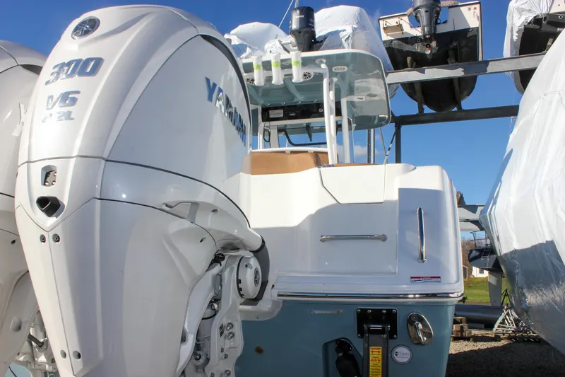 Slide: The Image of 2026 Sea Hunt Ultra 285 SE boat with Yamaha 300 V6 engine, docked outdoors. - 4