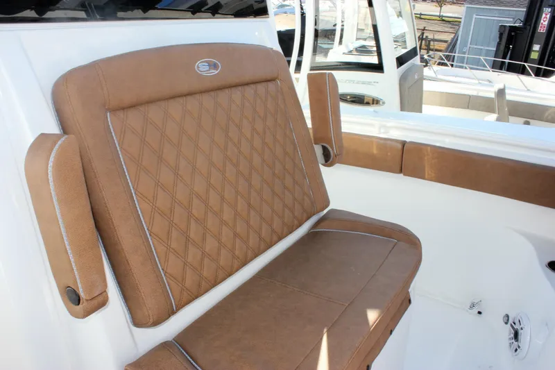 Slide: The Image of 2026 Sea Hunt Ultra 285 SE boat with brown cushioned seating. - 40