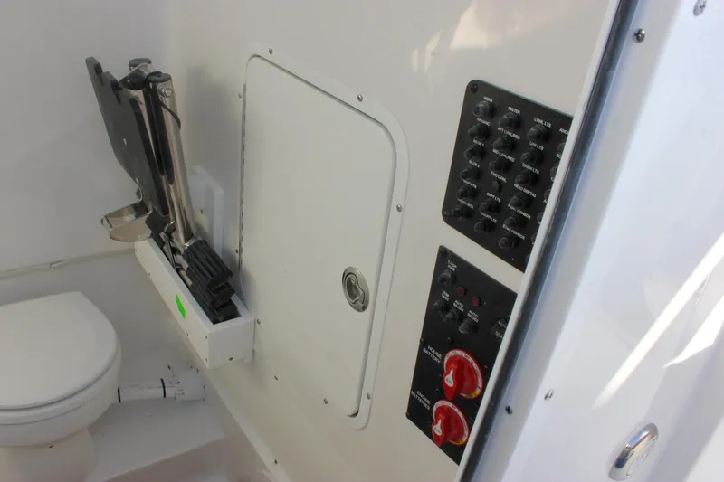 Slide: The Image of 2026 Sea Hunt Ultra 285 SE boat interior with control panel and toilet. - 43