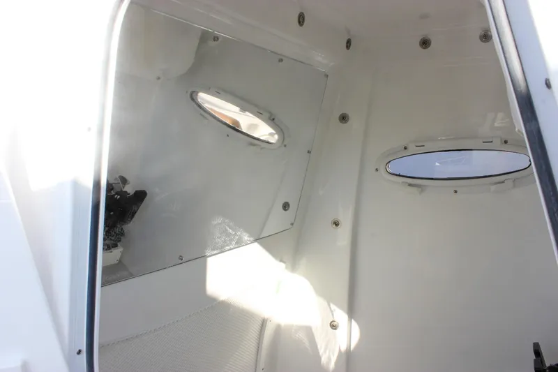 Slide: The Image of Interior cabin of 2026 Sea Hunt Ultra 285 SE boat with oval windows. - 44