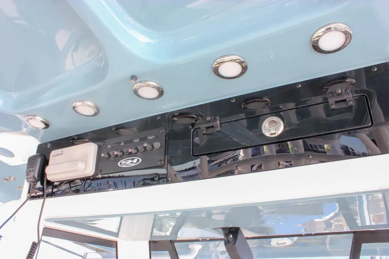 Slide: The Image of 2026 Sea Hunt Ultra 285 SE boat console with Garmin equipment and overhead lighting. - 48