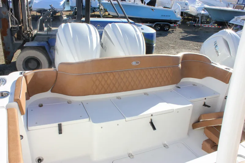 Slide: The Image of 2026 Sea Hunt Ultra 285 SE boat interior with tan seating and storage compartments. - 51