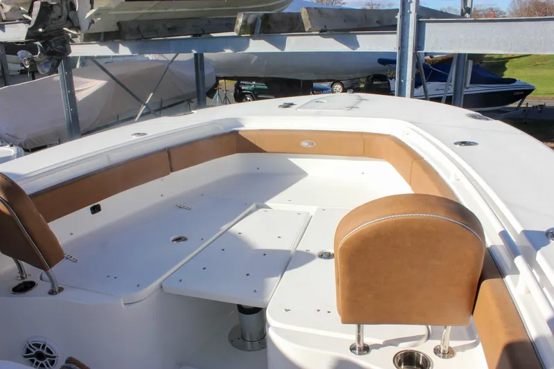 Slide: The Image of 2026 Sea Hunt Ultra 285 SE boat interior with tan seating and white deck. - 55