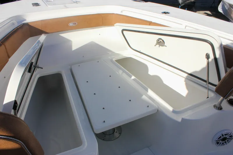 Slide: The Image of 2026 Sea Hunt Ultra 285 SE boat interior with storage compartments and seating. - 57
