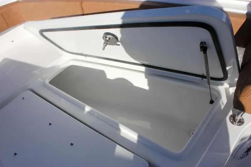 Slide: The Image of Open storage compartment on 2026 Sea Hunt Ultra 285 SE boat, featuring cushioned seating. - 58