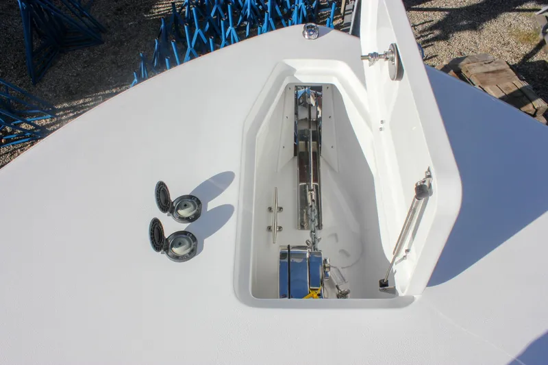 Slide: The Image of 2026 Sea Hunt Ultra 285 SE boat anchor compartment with open hatch and fittings. - 61
