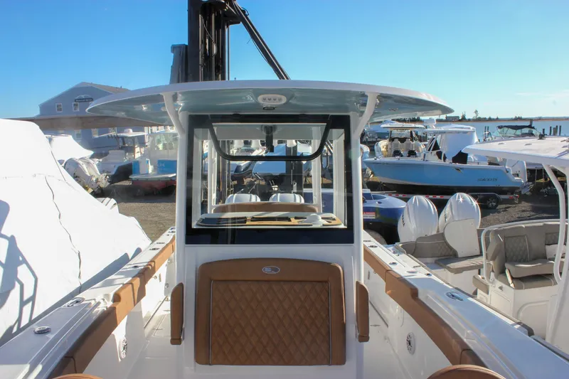 Slide: The Image of 2026 Sea Hunt Ultra 285 SE boat docked, showcasing sleek design and spacious interior. - 64