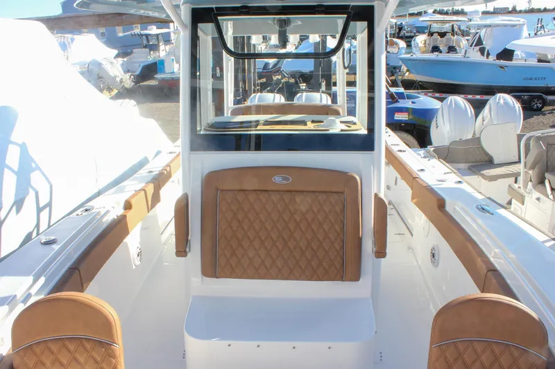 Slide: The Image of 2026 Sea Hunt Ultra 285 SE boat interior with tan seating and modern design. - 66