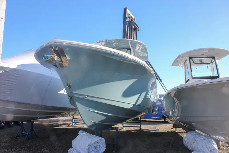 Slide: The Image of 2026 Sea Hunt Ultra 285 SE boat displayed outdoors under clear blue sky. - 71