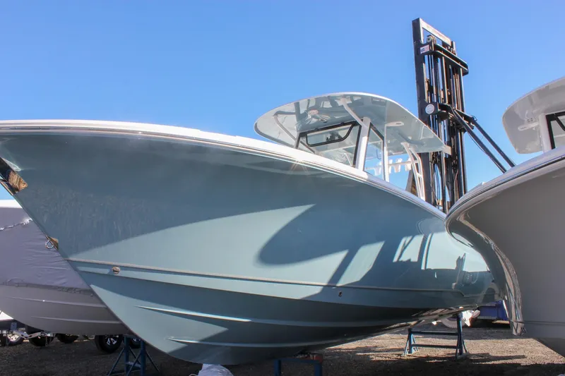 Slide: The Image of 2026 Sea Hunt Ultra 285 SE boat displayed outdoors under clear blue sky. - 72