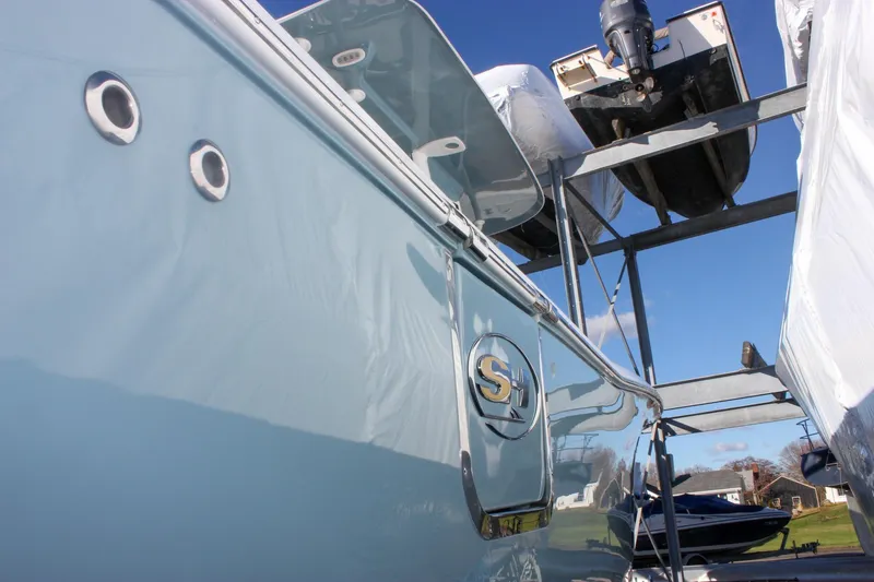 Slide: The Image of 2026 Sea Hunt Ultra 285 SE boat in storage, showcasing sleek design and logo. - 9