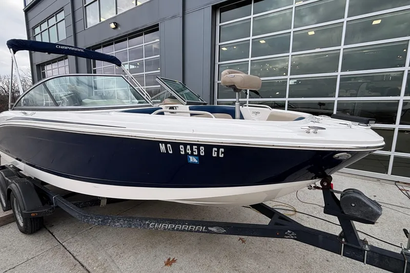 Slide: The Image of 2016 Chaparral 210 Suncoast Ski & Fish boat on trailer, parked outside a building. - 15