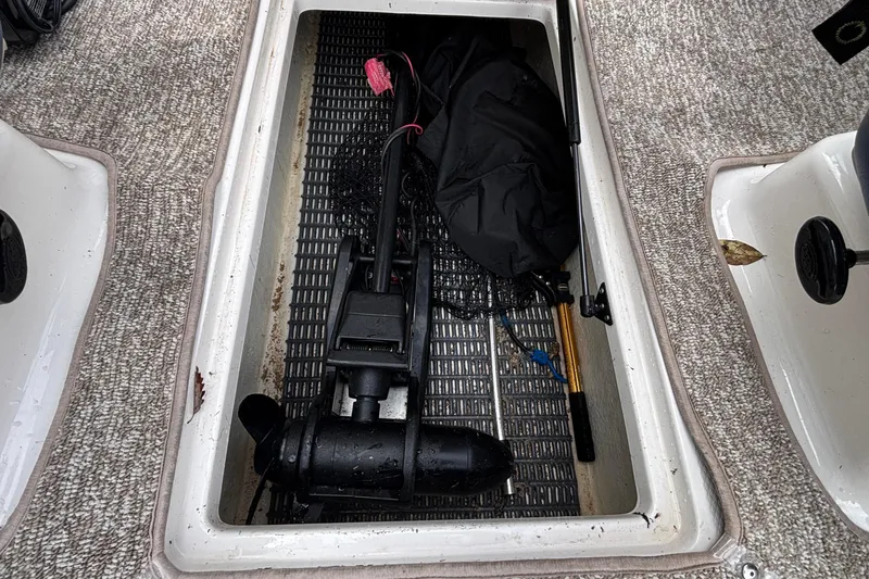Slide: The Image of Storage compartment in 2016 Chaparral 210 Suncoast Ski & Fish boat with fishing gear. - 16