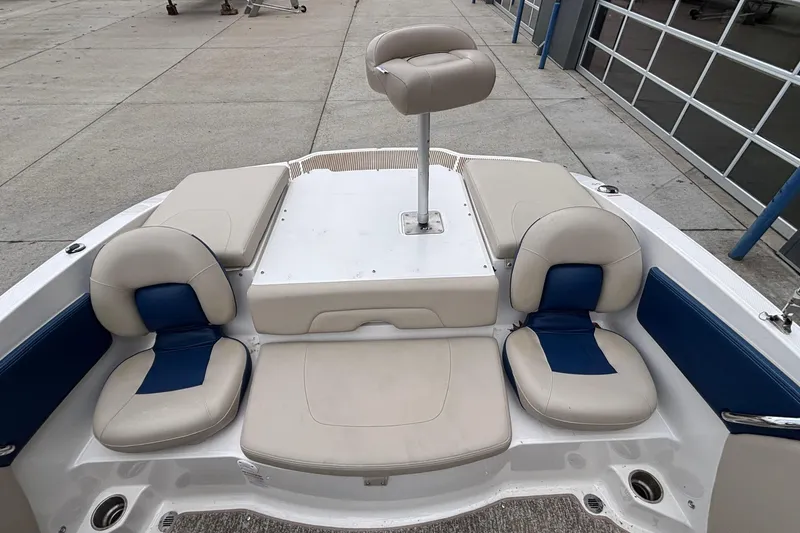 Slide: The Image of 2016 Chaparral 210 Suncoast Ski & Fish boat interior with beige and blue seating. - 17