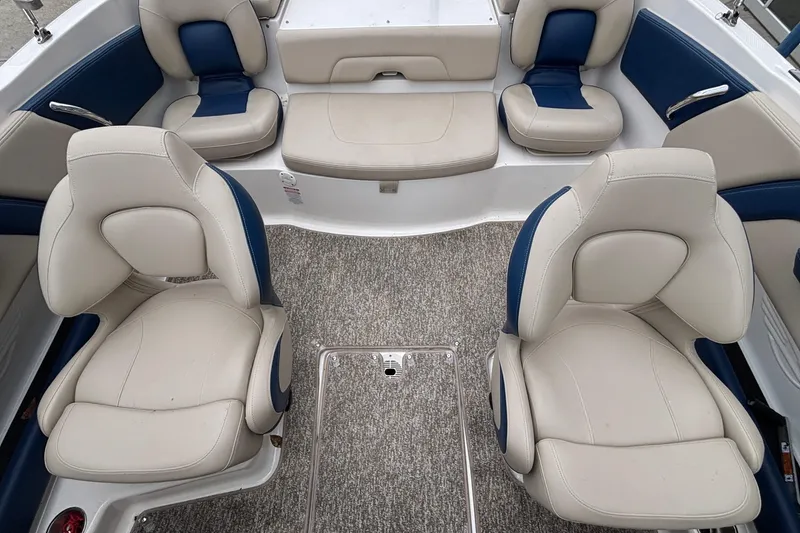 Slide: The Image of 2016 Chaparral 210 Suncoast Ski & Fish boat interior with plush seating and carpeted floor. - 18