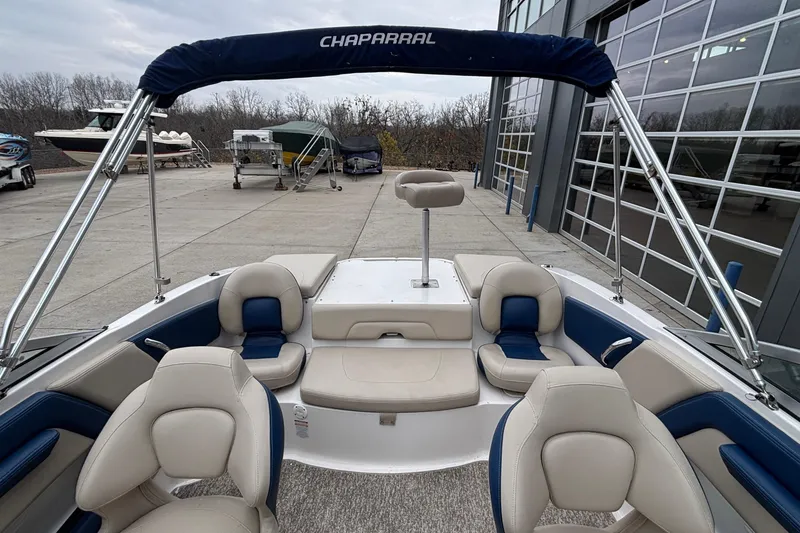 Slide: The Image of 2016 Chaparral 210 Suncoast Ski & Fish boat interior with seating and canopy. - 19
