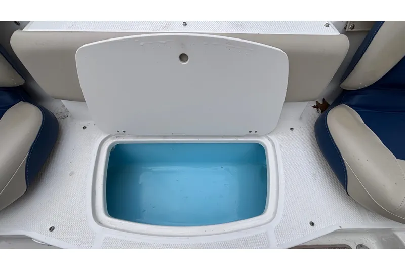 Slide: The Image of 2016 Chaparral 210 Suncoast Ski & Fish boat storage compartment with open lid. - 20