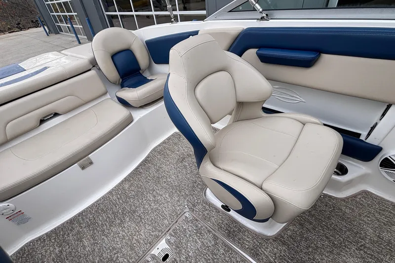 Slide: The Image of 2016 Chaparral 210 Suncoast Ski & Fish boat interior with beige and blue seating. - 23