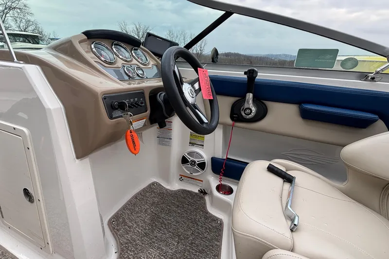 Slide: The Image of Interior of 2016 Chaparral 210 Suncoast Ski & Fish boat, featuring dashboard and steering wheel. - 25