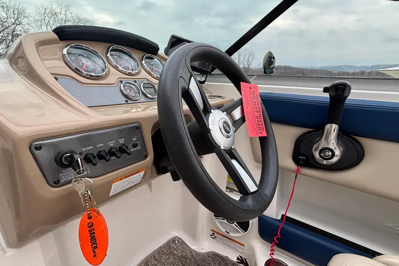 Slide: The Image of 2016 Chaparral 210 Suncoast Ski & Fish boat dashboard with steering wheel and controls. - 26