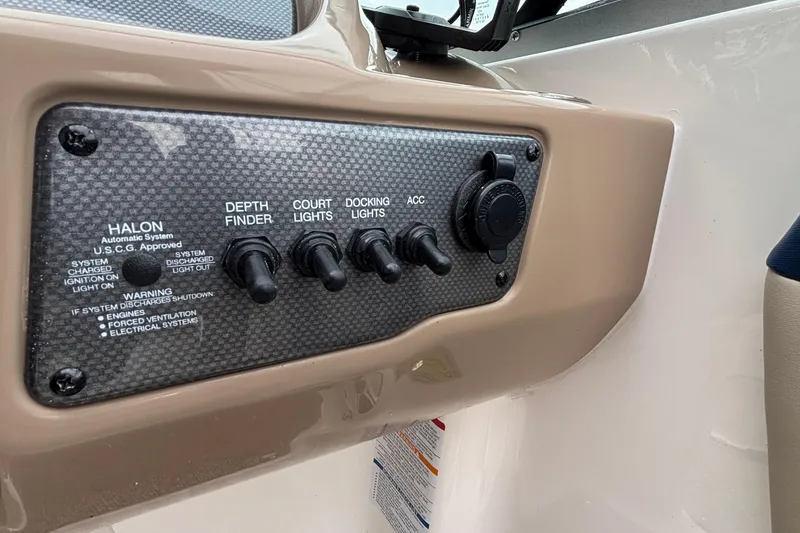 Slide: The Image of Control panel of 2016 Chaparral 210 Suncoast Ski & Fish boat with switches and halon system. - 27