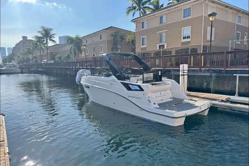 Slide: The Image of Luxury Granfort 300 GTS boat at sunset, city skyline in background, 2026 model. - 1