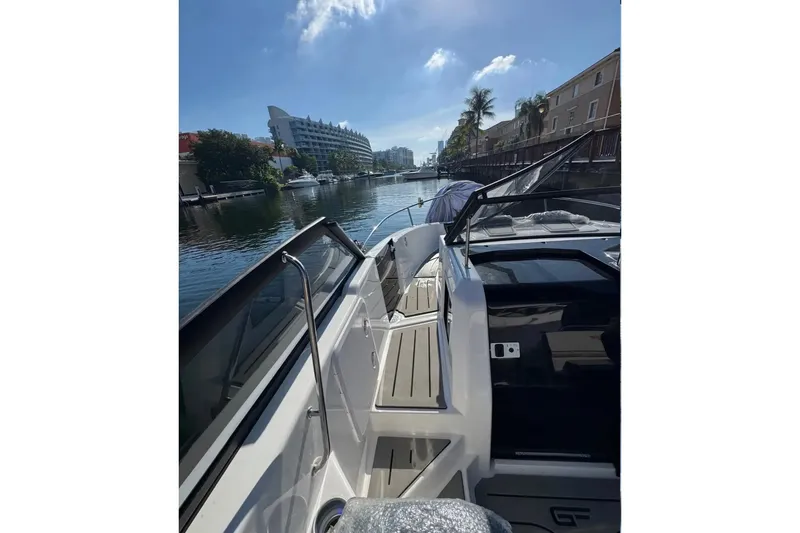 Slide: The Image of 2026 Granfort 300 GTS luxury boat docked at marina, rear view. - 3