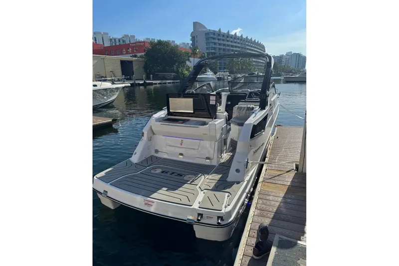 Slide: The Image of 2026 Granfort 300 GTX boat with city skyline in the background. - 2