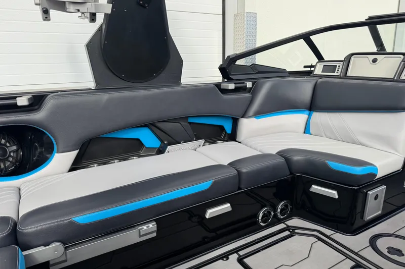 Slide: The Image of 2021 Supra SA 575 boat interior with sleek black, white, and blue seating design. - 10