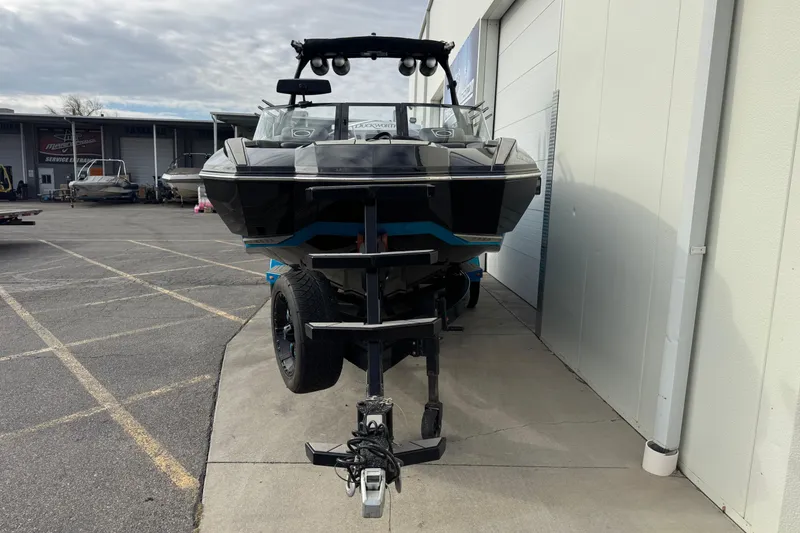 Slide: The Image of 2021 Supra SA 575 boat on trailer parked outside a service center. - 4