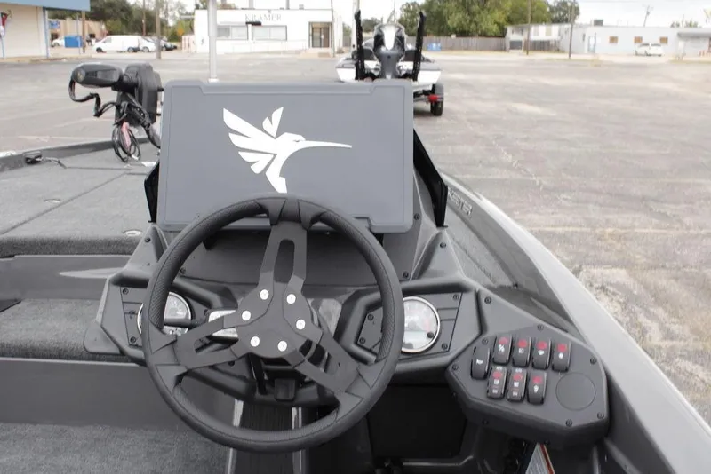 Slide: The Image of Interior view of 2026 Skeeter ZXE20 boat dashboard with steering wheel and control panel. - 23