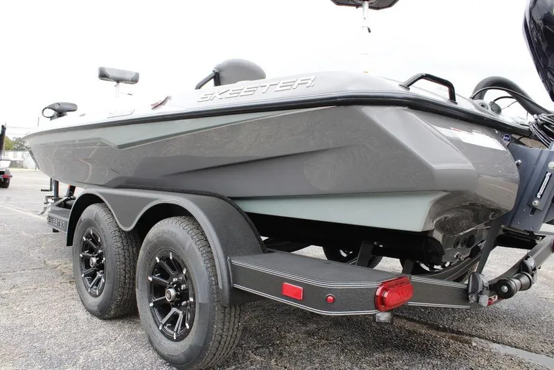 Slide: The Image of 2026 Skeeter ZXE20 boat on trailer, showcasing sleek design and dual-axle wheels. - 26