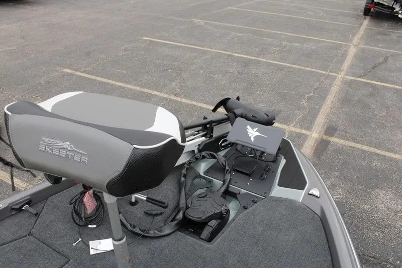 Slide: The Image of 2026 Skeeter ZXE20 boat seat and control panel in a parking lot. - 8