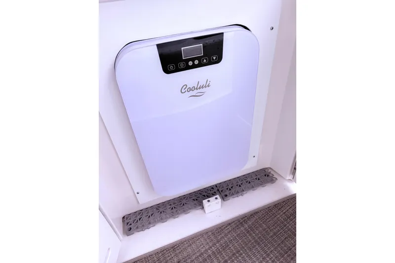 Slide: The Image of Bathroom interior of 2001 Sea Ray 340 Sundancer yacht with compact design and wooden floor mat. - 16