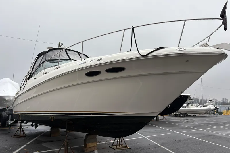Slide: The Image of Side view of a 2001 Sea Ray 340 Sundancer docked on a sunny day. - 2