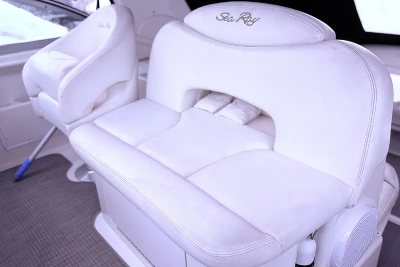 Slide: The Image of Interior seating of a 2001 Sea Ray 340 Sundancer boat, featuring white upholstery. - 21