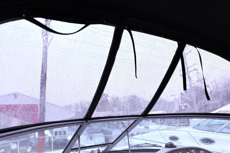 Slide: The Image of 2001 Sea Ray 340 Sundancer docked by a scenic waterfront with trees and blue sky. - 3