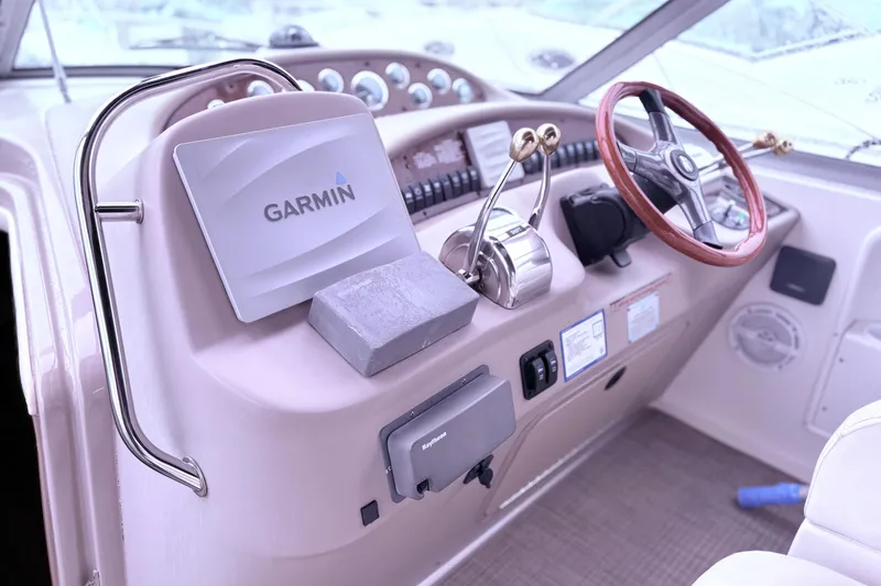 Slide: The Image of 2001 Sea Ray 340 Sundancer boat on stands in a parking lot. - 4