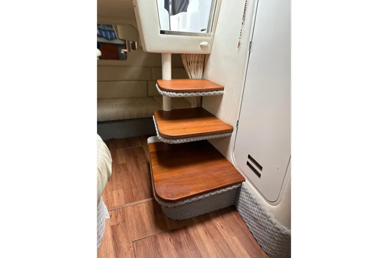 Slide: The Image of Interior of 2001 Sea Ray 340 Sundancer yacht with elegant seating and wooden accents. - 9