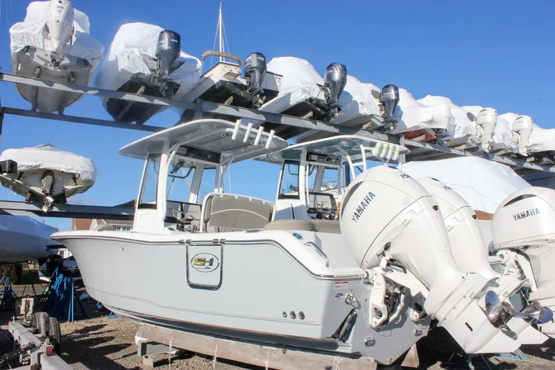 The Image of 2026 Sea Hunt Ultra 265 SE boat with Yamaha engines in storage facility. - 0