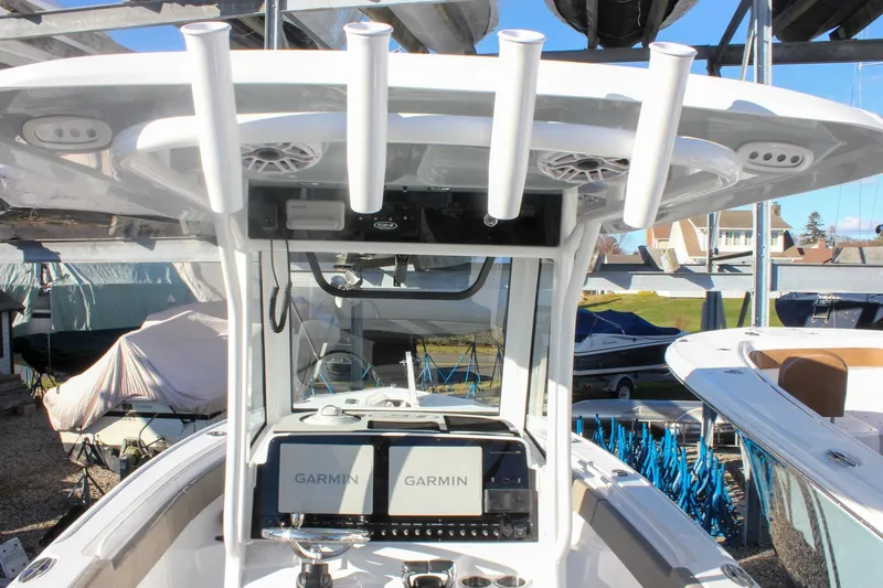 Slide: The Image of 2026 Sea Hunt Ultra 265 SE boat with Garmin navigation system and rod holders. - 11