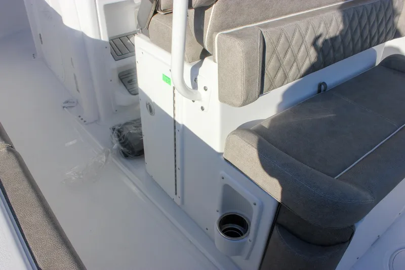 Slide: The Image of 2026 Sea Hunt Ultra 265 SE boat interior with gray cushioned seating. - 14
