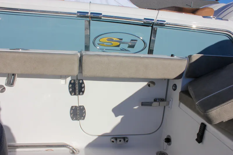 Slide: The Image of 2026 Sea Hunt Ultra 265 SE boat interior with seating and logo detail. - 18